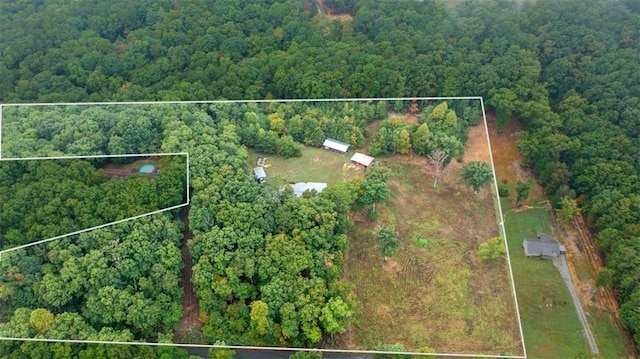 birds eye view of property featuring a view of trees