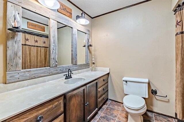 bathroom featuring toilet, a textured ceiling, and vanity