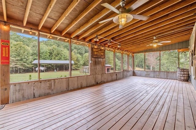 unfurnished sunroom featuring a ceiling fan