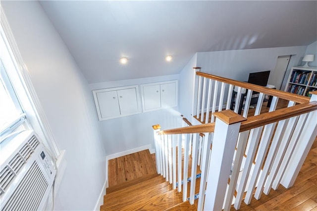 stairway featuring baseboards and wood finished floors