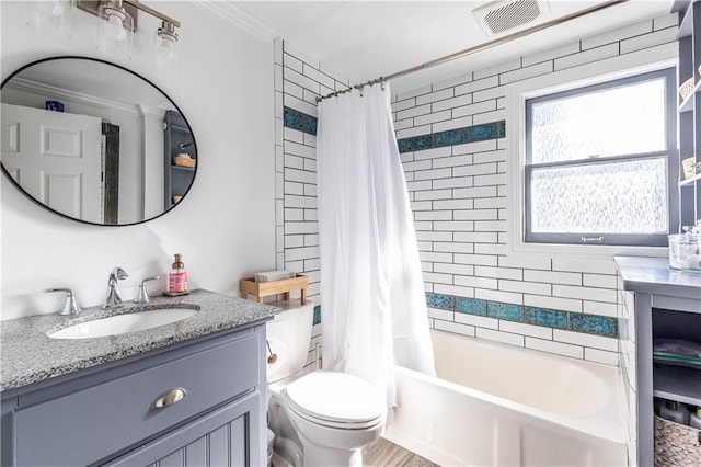 full bath with visible vents, toilet, ornamental molding, shower / bath combo, and vanity