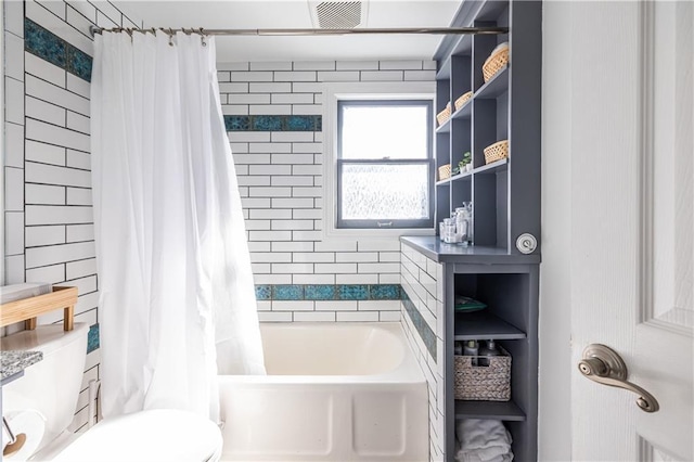 full bath with visible vents, toilet, and shower / bath combo with shower curtain