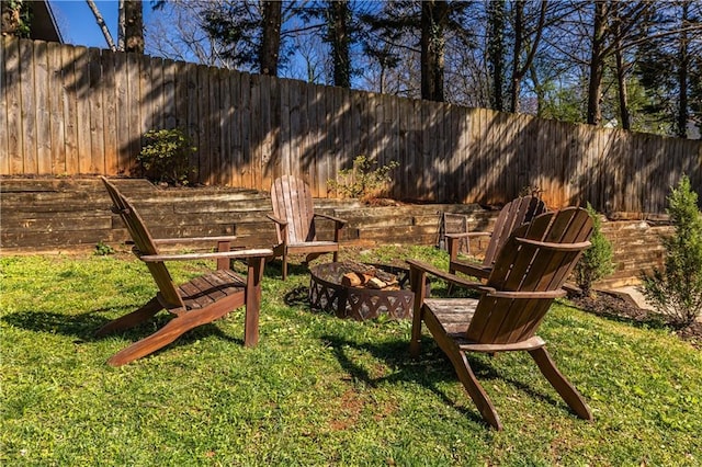 view of yard featuring a fire pit and a fenced backyard