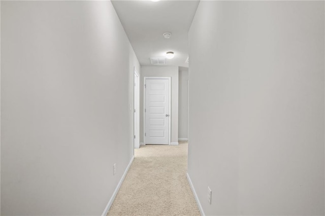 hallway featuring light carpet