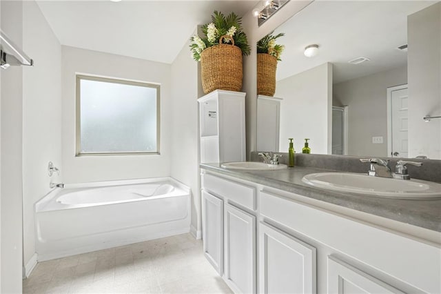 bathroom with vanity and a bath