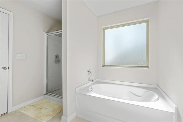 bathroom featuring shower with separate bathtub