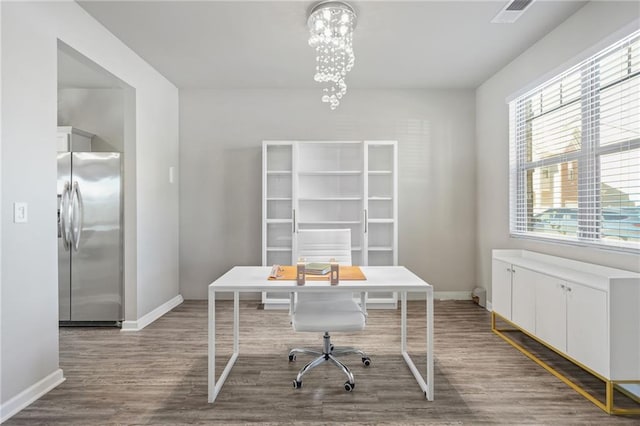 home office featuring hardwood / wood-style flooring and an inviting chandelier