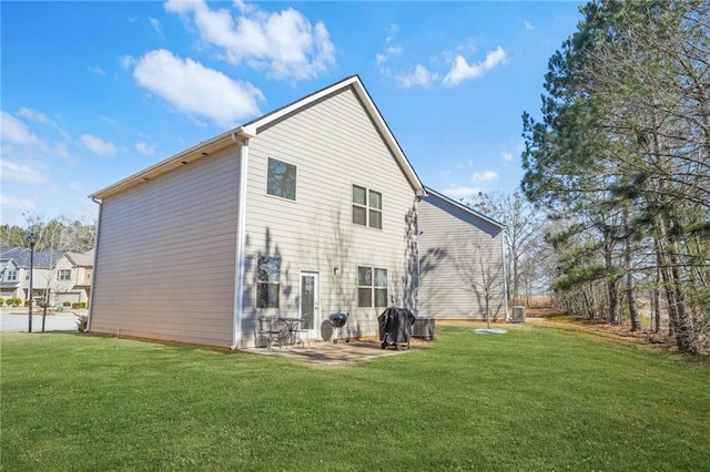 back of property with a yard and a patio area