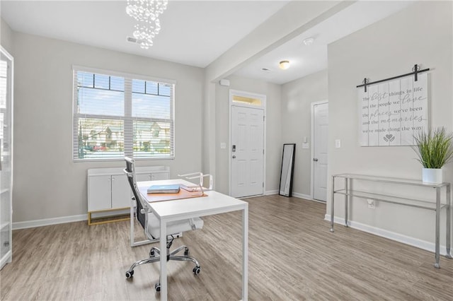 office area with a chandelier and light hardwood / wood-style floors