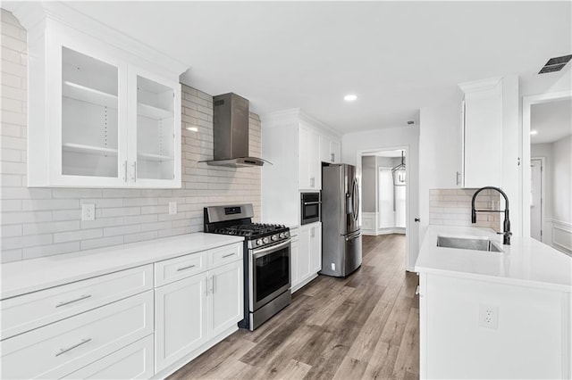 615 Rosedown Way, Alpharetta, GA 30022 - kitchen with stainless steel appliances, wall chimney exhaust hood, tasteful backsplash, white cabinetry, and recessed lighting