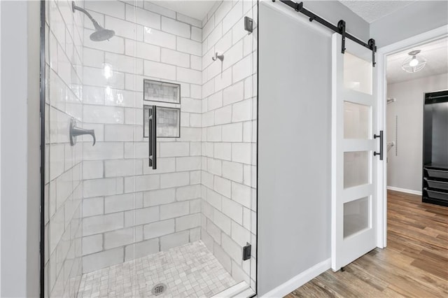 615 Rosedown Way, Alpharetta, GA 30022 - bathroom with a stall shower, wood finished floors, and a textured ceiling