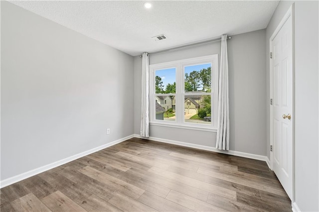 615 Rosedown Way, Alpharetta, GA 30022 - unfurnished room featuring a textured ceiling, wood finished floors, and recessed lighting