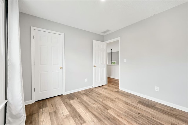 615 Rosedown Way, Alpharetta, GA 30022 - unfurnished bedroom with light wood-type flooring and baseboards