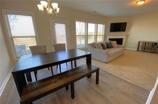 carpeted dining room featuring an inviting chandelier