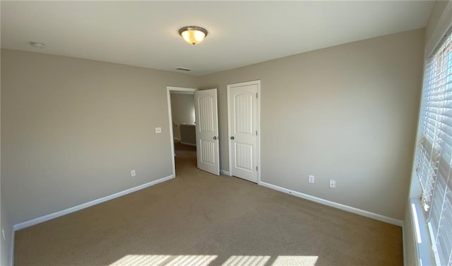 unfurnished bedroom with carpet floors and a closet