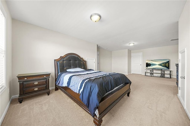 carpeted bedroom featuring baseboards