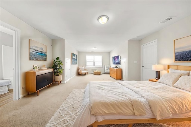 bedroom featuring light carpet, visible vents, and baseboards