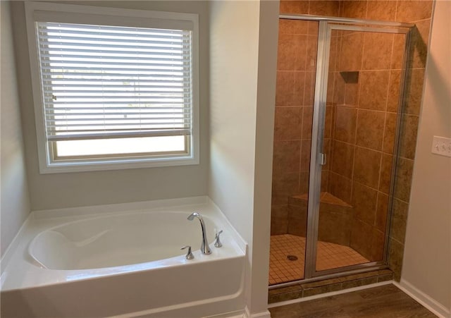 bathroom featuring plus walk in shower and a wealth of natural light