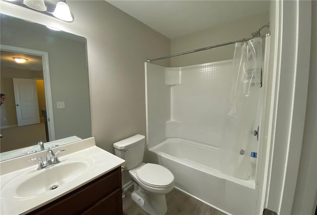 full bathroom featuring shower / bath combo, vanity, hardwood / wood-style flooring, and toilet