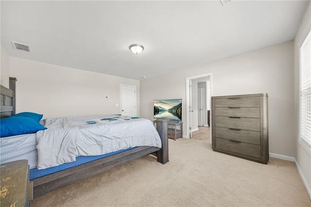 bedroom featuring baseboards, visible vents, and light colored carpet