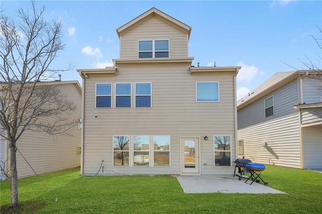 back of house featuring a patio area and a yard