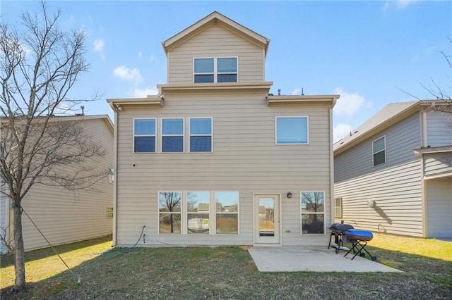 back of property featuring a lawn and a patio