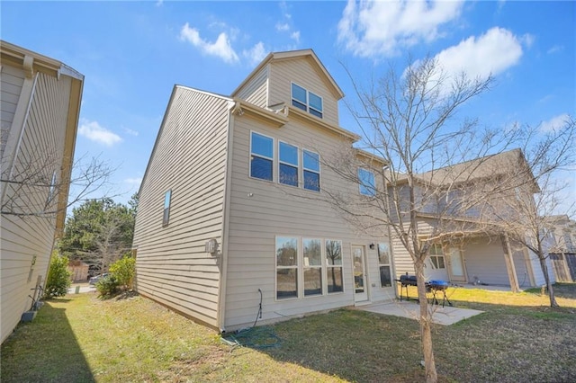 rear view of house featuring a patio area and a yard
