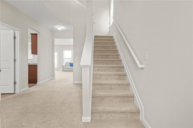 stairs with carpet and baseboards