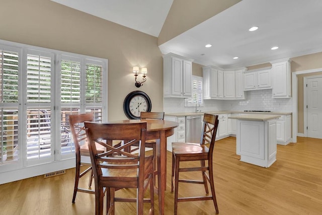 dining area with recessed lighting, visible vents, lofted ceiling, and light wood-style floors
