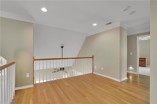interior space with visible vents, ornamental molding, baseboards, and wood finished floors