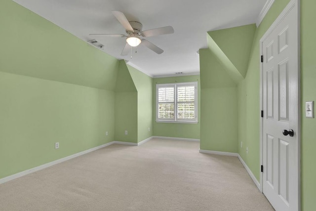 bonus room featuring baseboards, a ceiling fan, light colored carpet, and visible vents