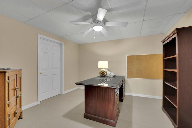 office space with baseboards, ceiling fan, and light colored carpet