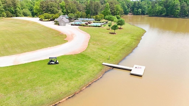 drone / aerial view featuring a water view and a forest view