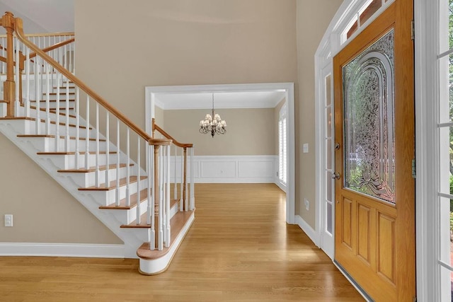 entryway featuring stairs, plenty of natural light, ornamental molding, and wood finished floors