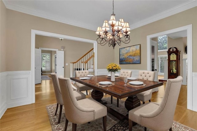 dining area with light wood-style flooring, a chandelier, and a healthy amount of sunlight