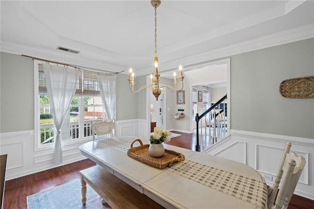 121 Bradshaw Park Dr, Woodstock, GA 30188 - dining room featuring a chandelier, wainscoting, a decorative wall, dark wood-type flooring, and crown molding