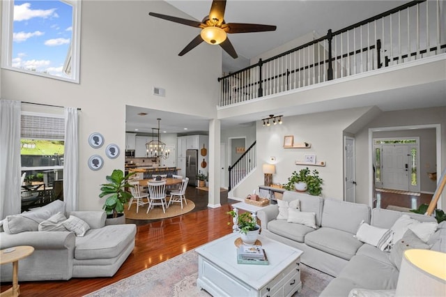 121 Bradshaw Park Dr, Woodstock, GA 30188 - living area with stairway, wood finished floors, a towering ceiling, a chandelier, and ceiling fan