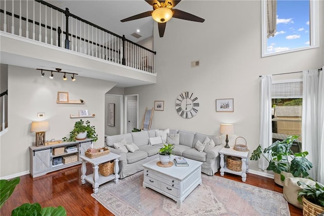 121 Bradshaw Park Dr, Woodstock, GA 30188 - living room with a towering ceiling, ceiling fan, wood finished floors, and baseboards
