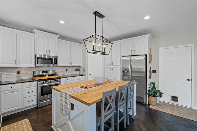 121 Bradshaw Park Dr, Woodstock, GA 30188 - kitchen with stainless steel appliances, white cabinets, wooden counters, decorative backsplash, and recessed lighting