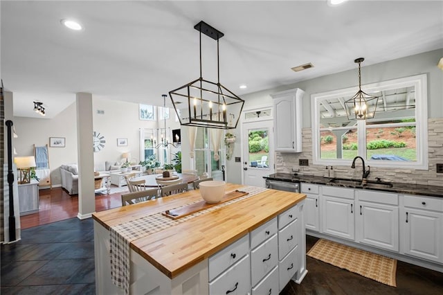 121 Bradshaw Park Dr, Woodstock, GA 30188 - kitchen with a sink, a chandelier, wood counters, white cabinets, and backsplash