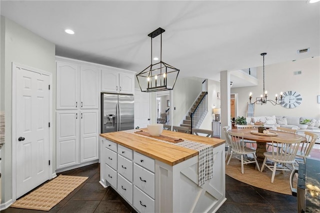 121 Bradshaw Park Dr, Woodstock, GA 30188 - kitchen featuring butcher block countertops, a chandelier, stainless steel fridge, white cabinetry, and hanging light fixtures