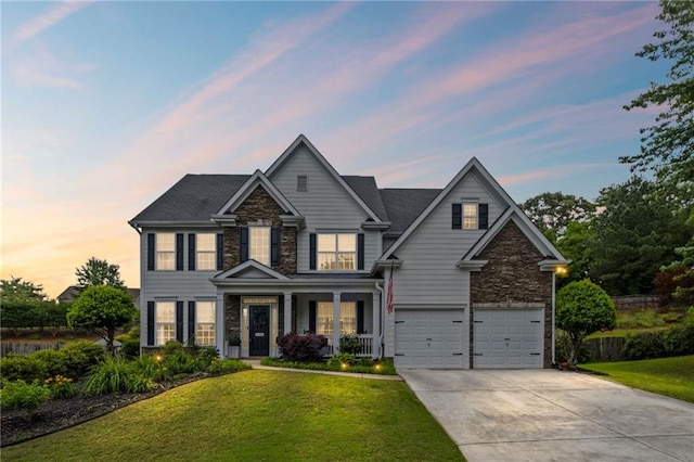 121 Bradshaw Park Dr, Woodstock, GA 30188 - view of front of property featuring a garage, concrete driveway, stone siding, and a front yard