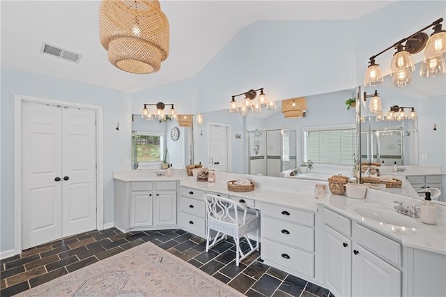 121 Bradshaw Park Dr, Woodstock, GA 30188 - full bath featuring a stall shower, vaulted ceiling, two vanities, and a chandelier