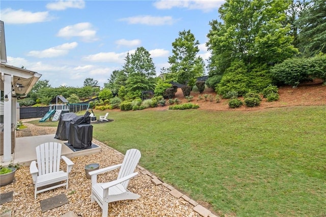 121 Bradshaw Park Dr, Woodstock, GA 30188 - view of grassy yard with a playground and a patio area