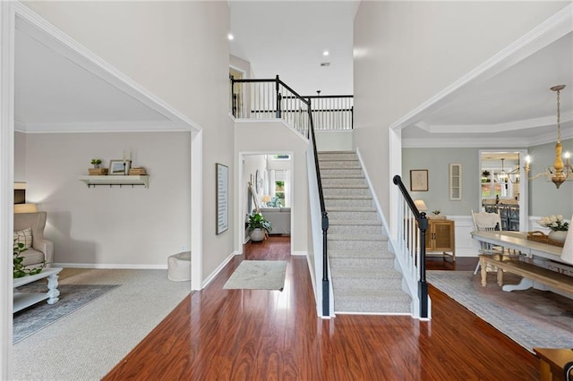 121 Bradshaw Park Dr, Woodstock, GA 30188 - foyer entrance featuring stairs, wood finished floors, baseboards, a chandelier, and a towering ceiling