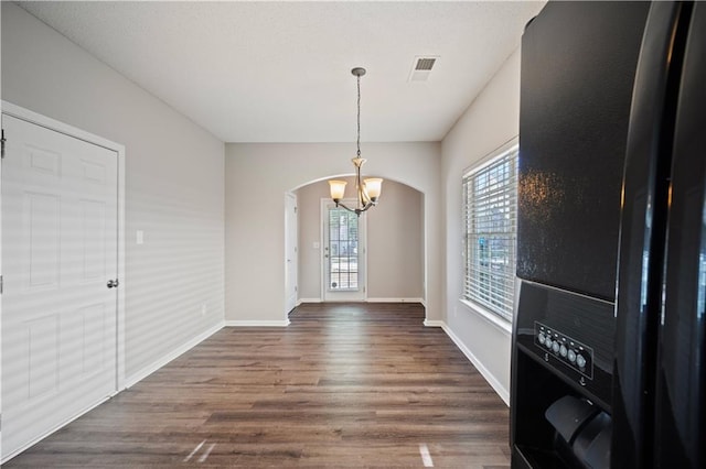 3223 Tallon Ln SW, Atlanta, GA 30311 - unfurnished dining area with arched walkways, a chandelier, dark wood-style flooring, and baseboards