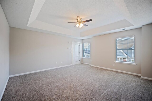 3223 Tallon Ln SW, Atlanta, GA 30311 - carpeted empty room featuring a tray ceiling, ceiling fan, baseboards, and a textured ceiling