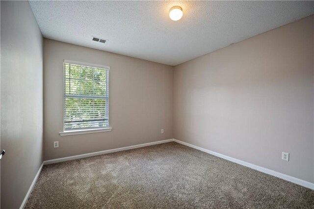 3223 Tallon Ln SW, Atlanta, GA 30311 - carpeted spare room with a textured ceiling and baseboards