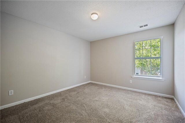 3223 Tallon Ln SW, Atlanta, GA 30311 - spare room with carpet flooring, a textured ceiling, and baseboards