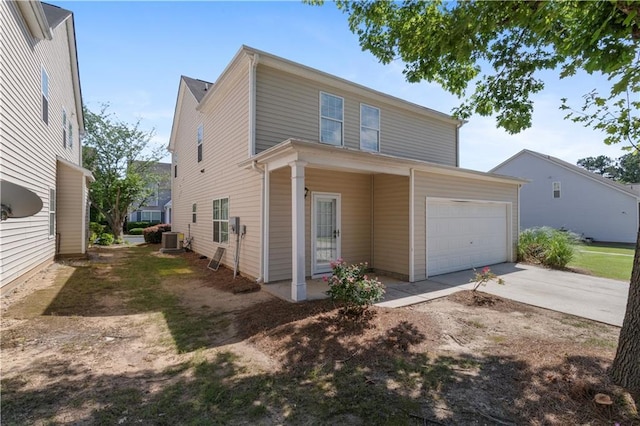 3223 Tallon Ln SW, Atlanta, GA 30311 - traditional-style home featuring concrete driveway, central air condition unit, and an attached garage
